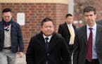 St. Paul City Council Member Dai Thao, left, walked with his attorney Joe Dixon, right, from the Ramsey County Law Enforcement Center following a hear
