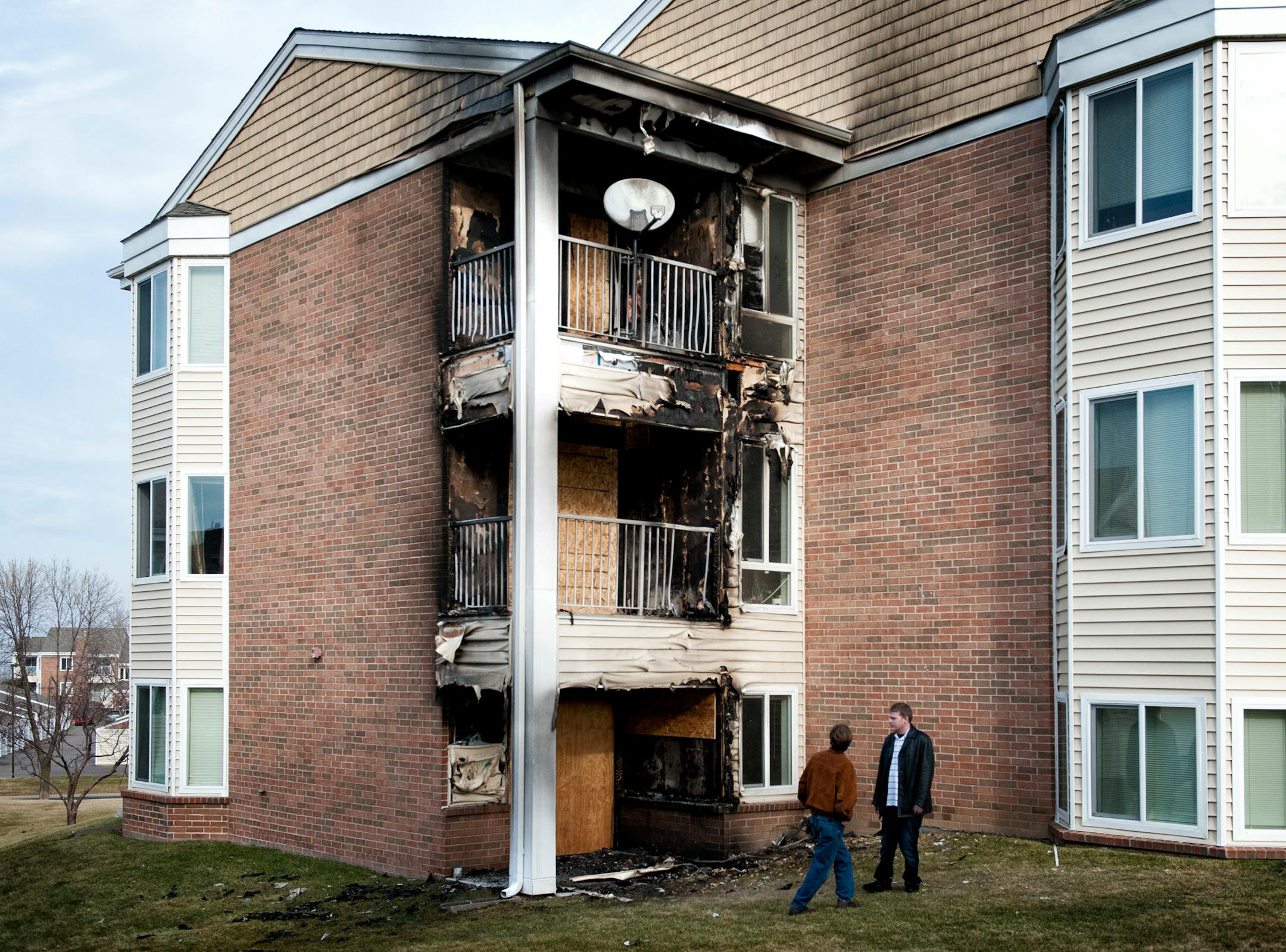 Neighbors looked at the damage. Residents of Cinnamon Ridge Apartments in Eagan awoke to a 3:30 am fire, Thursday, November 22, 2012. 24 units were evacuated and residents of 6 units were displaced.