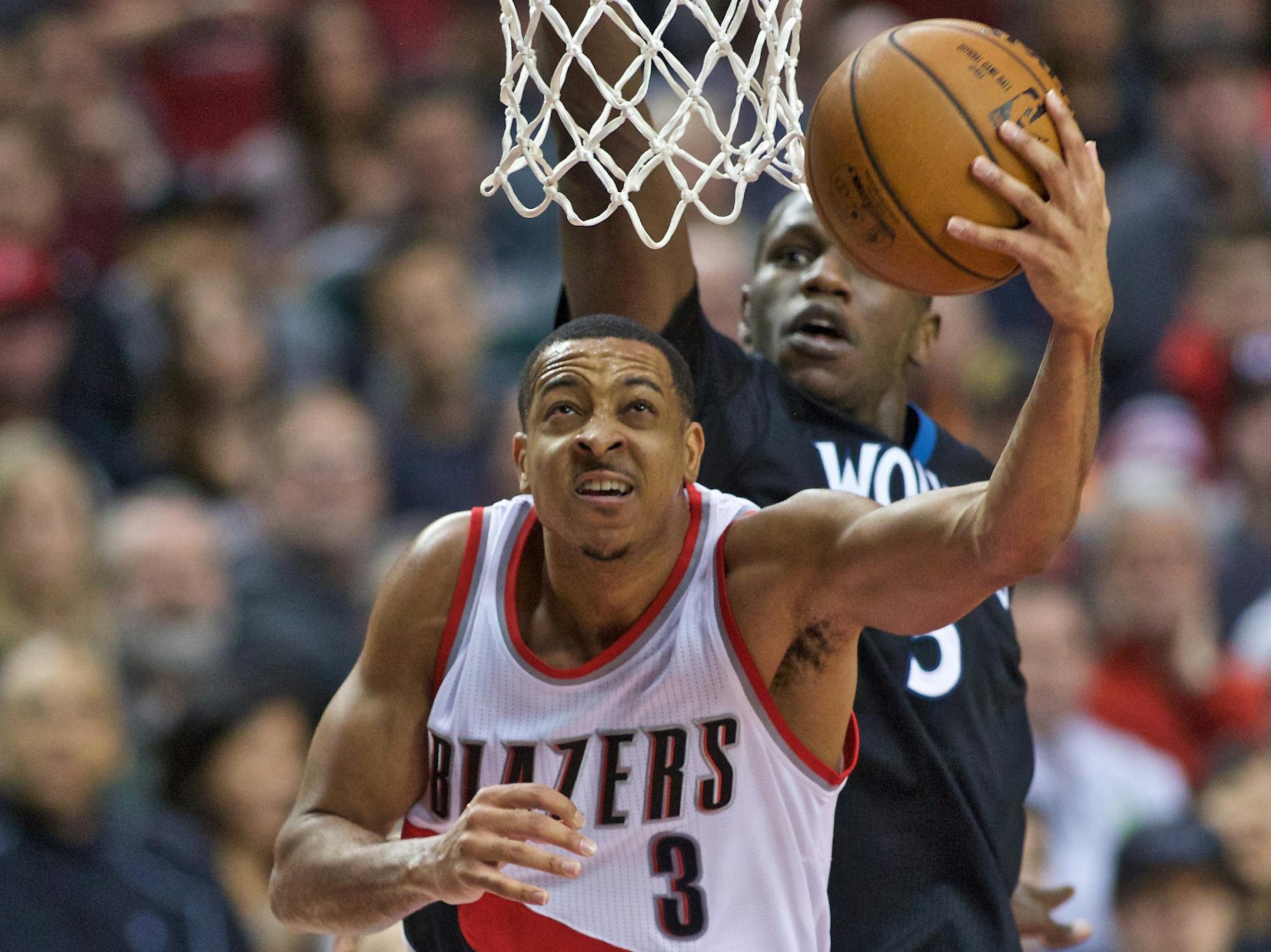 Portland's C.J. McCollum, left, shot over Timberwolves center Gorgui Dieng.