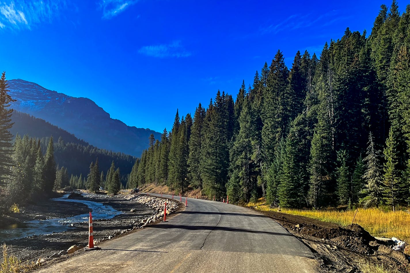 In a photo provided by the NPS shows, a stretch of Yellowstone National Park's Northeast Entrance Road showed signs of recent repairs and paving on Thursday. Northeast Entrance Road has been closed for four months since punishing floods damaged five sections of it, according to the National Park Service. (Cam Sholly/National Park Service via The New York Times) — EDITORIAL USE ONLY —