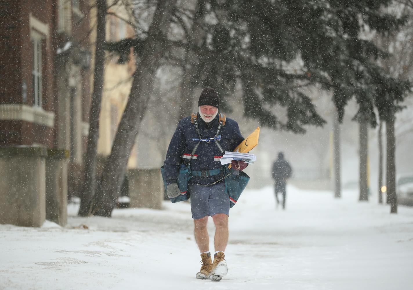 Mel Peterson delivered mail along his route in January 2018 on Park Avenue in Minneapolis. "I'm comfortable as long as I keep moving," he said. "At work, it's like 'it must be really cold out there if Mel's wearing pants.'"