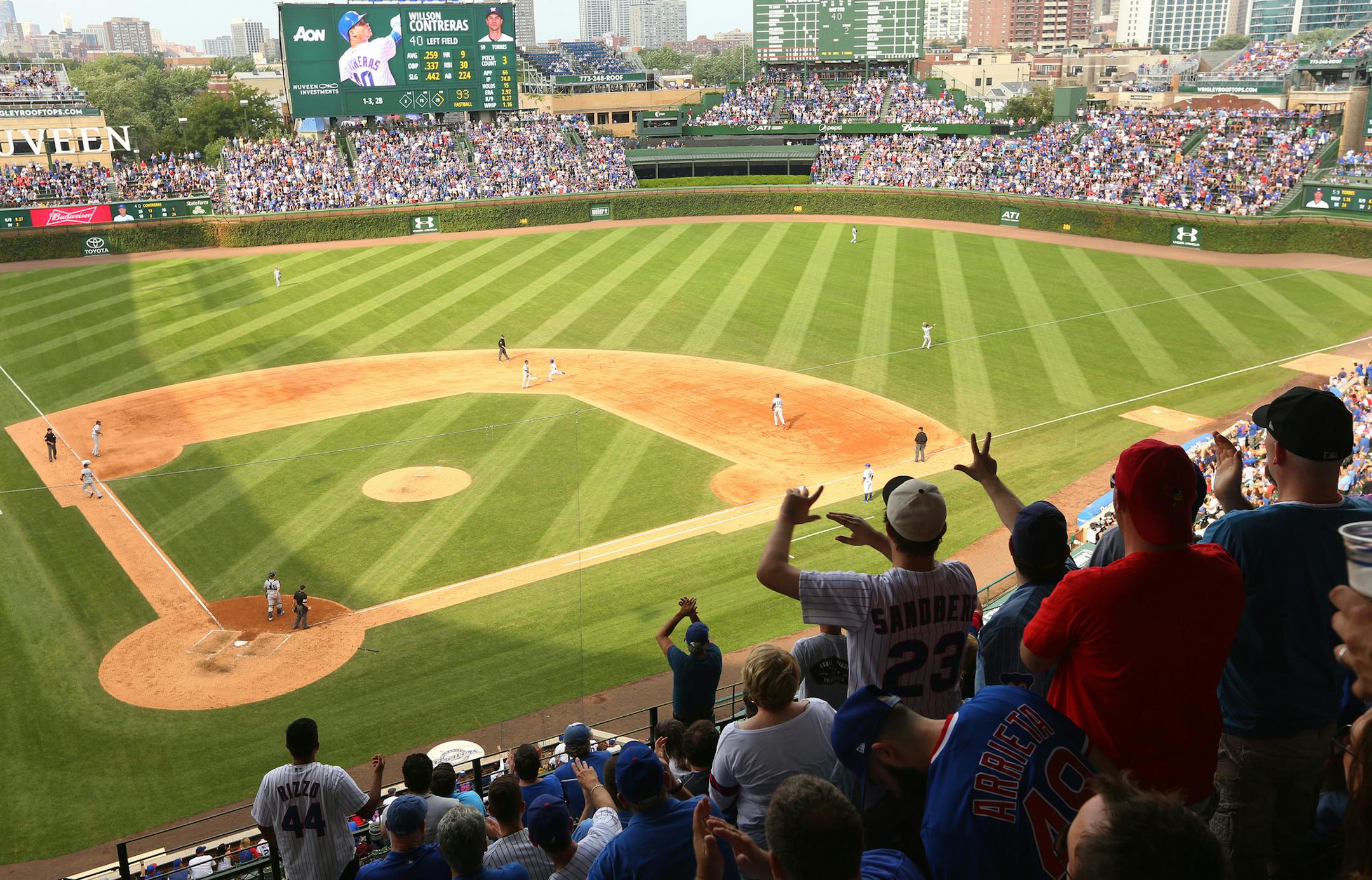 Fans urge on Willson Contreras as he doubles, beginning a ninth-inning come-back to tie the Brewers and later win the tenth inning at Wrigley Field Friday, Sept. 16, 2016 during the first home game after the Cubs clinched the the National League Division title. (Chris Walker/Chicago Tribune) ORG XMIT: 1190625 ORG XMIT: MIN1609231005166601