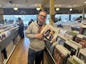 Electric Fetus music buyer Jim Novak holds up Dylan Records the day after actor Timothée Chalamet's visited Hibbing to prepare for a Bob Dylan biopic