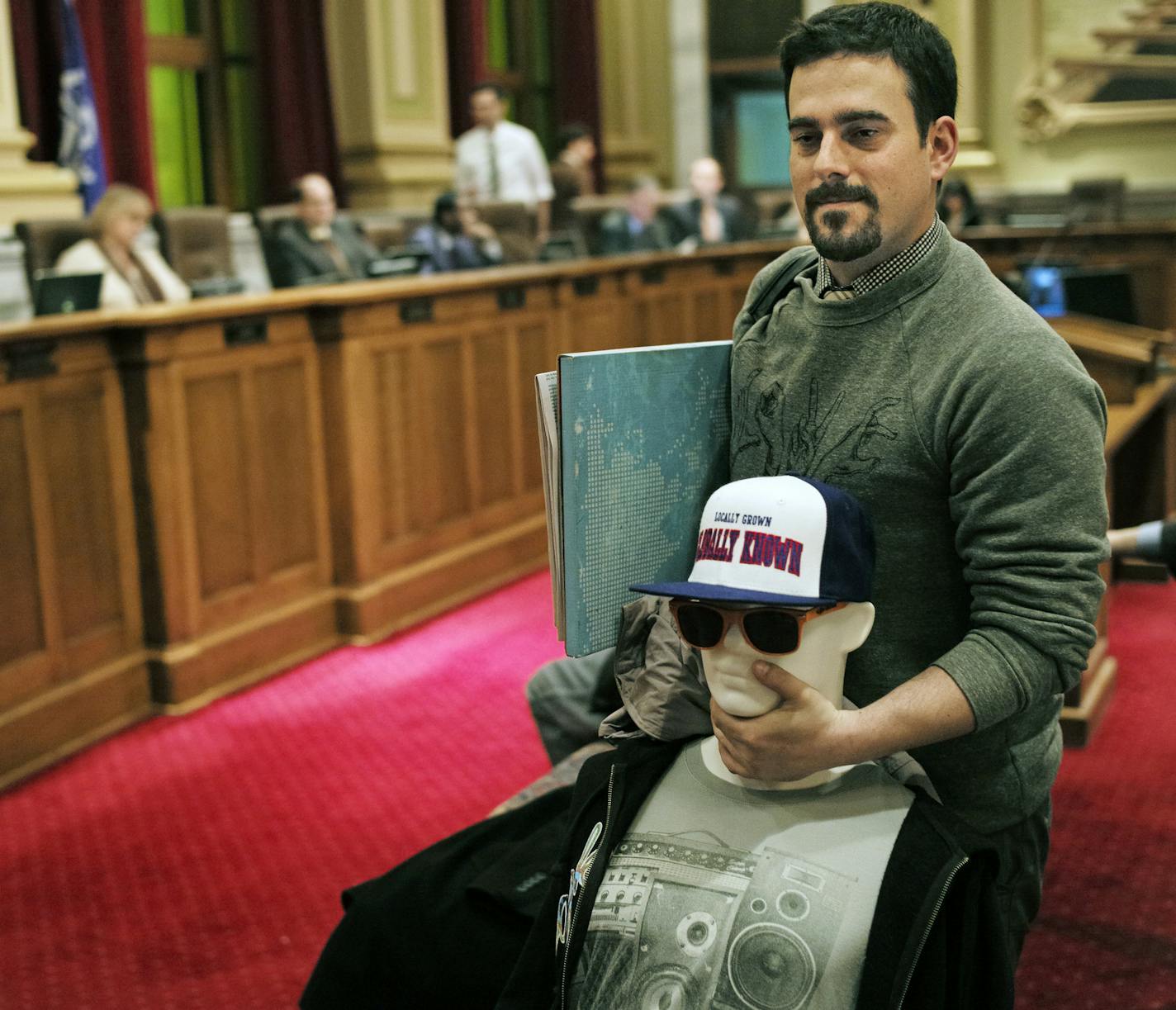 Brian Felsen, with his specially wired dummy designed to show the dangerous decibel levels from earbuds, testified in favor of the earplug measure Tuesday at Minneapolis City Hall.