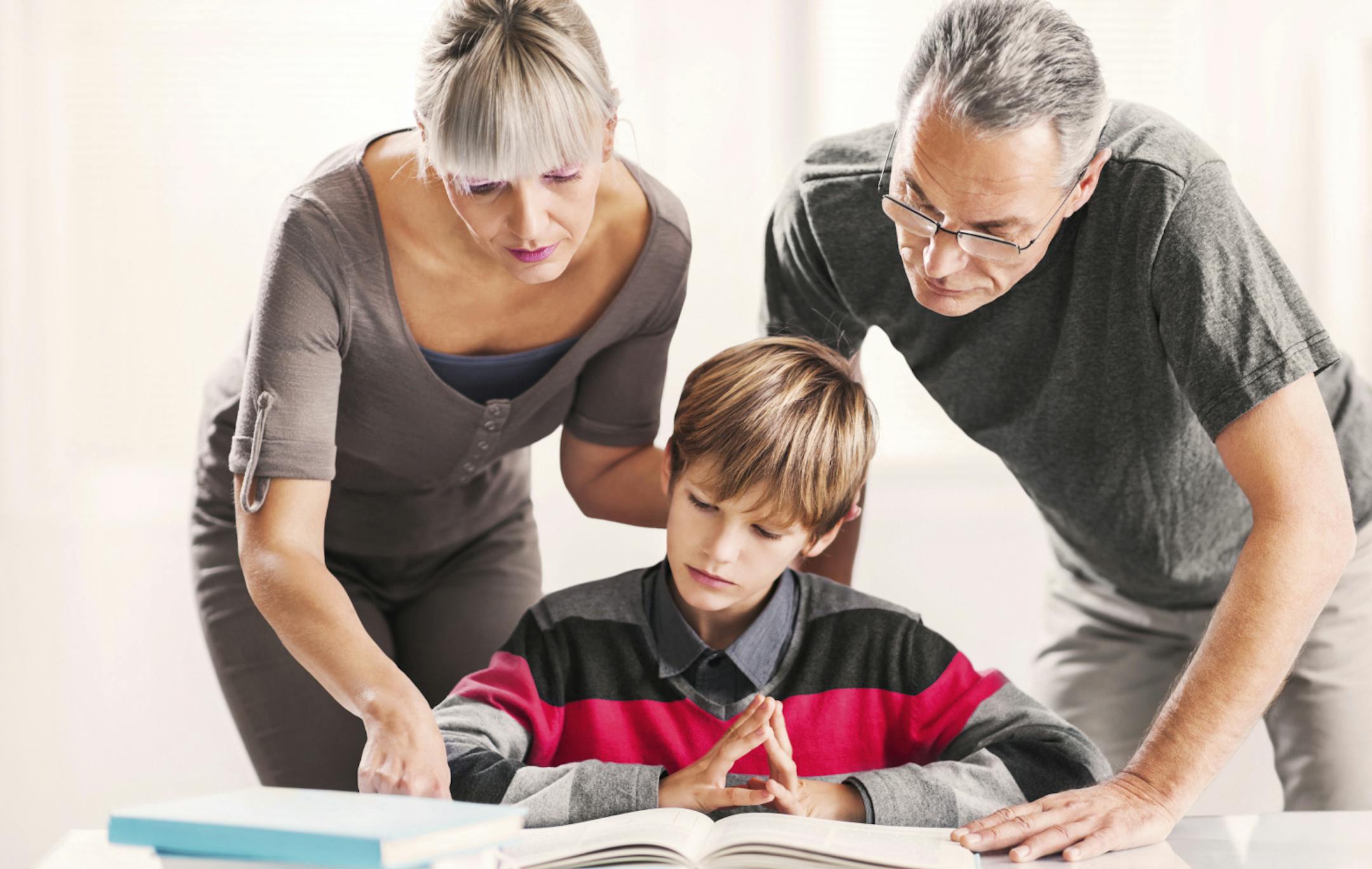 Mature parents helping their teenage son with his studying. Istock [url=http://www.istockphoto.com/search/lightbox/9786778][img]http://dl.dropbox.com/u/40117171/family.jpg[/img][/url]