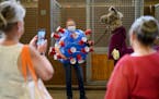 Dressed as the COVID-19 virus, Arabelle Rohs, of Sherburne County, stood with her llama, “Sherlock,” dressed as a doctor, before the start of the 