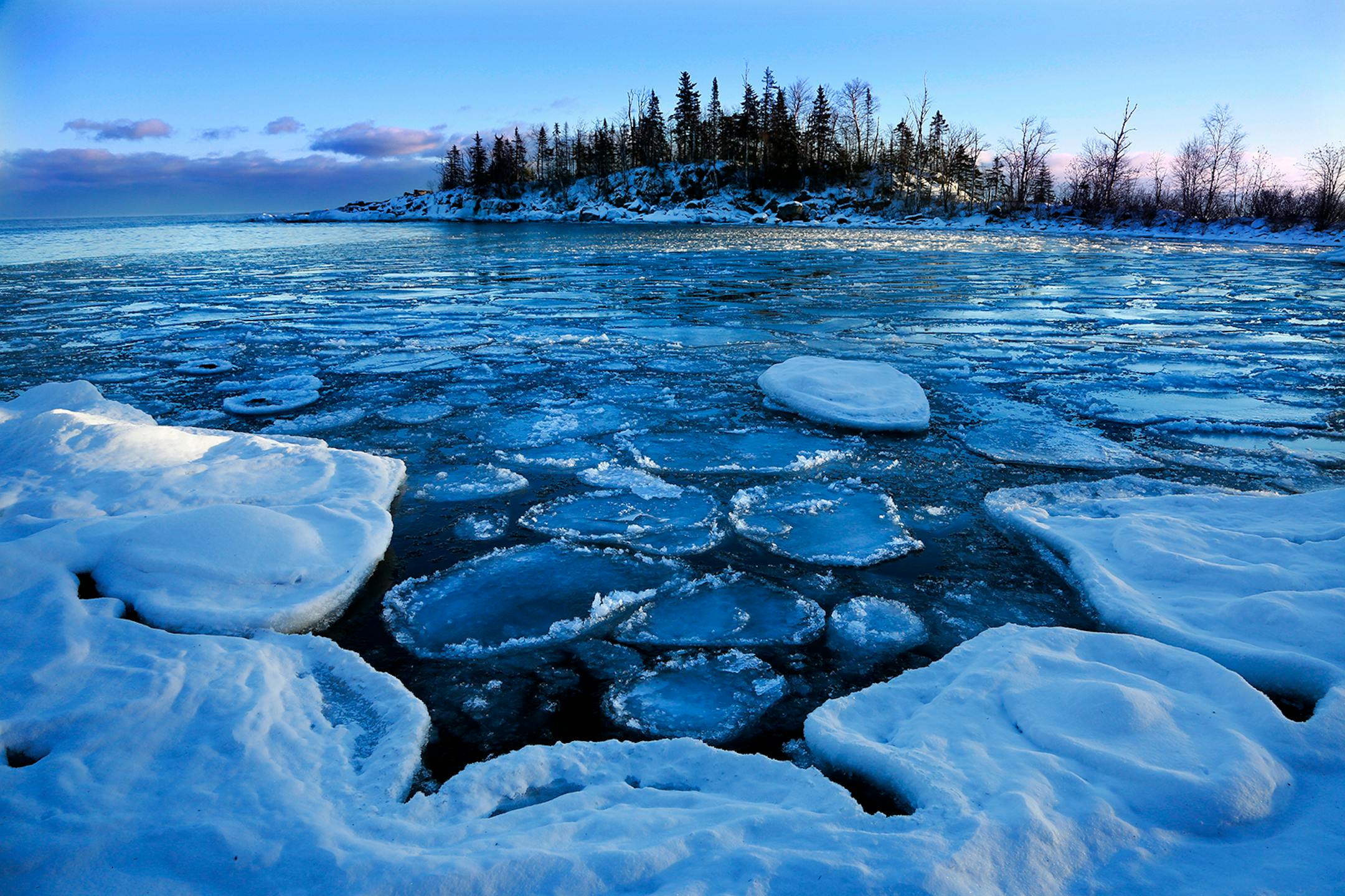 As Lake Superior struggled to freeze over, pancake ice developed in the bay near Cove Point. Researchers say Lake Superior is warming even faster than the global average.