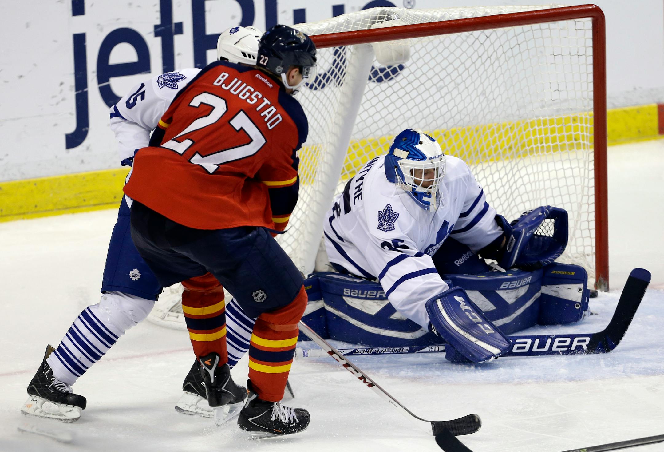 The puck gets past Toronto Maple Leafs goalie Drew MacIntyre, right, on a goal scored by Florida Panthers center Nick Bjugstad (27) in the third period of an NHL hockey game on Thursday, April 10, 2014, in Sunrise, Fla. The Panthers defeated the Maple Leafs 4-2. (AP Photo/Lynne Sladky)