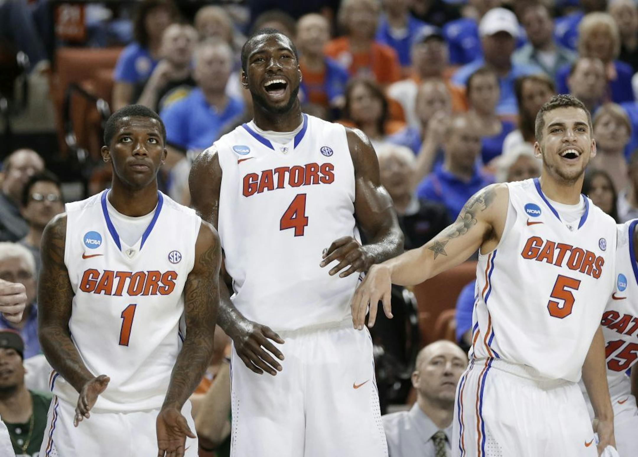 Florida's Kenny Boynton (1), Patric Young (4), and Scottie Wilbekin (5) watch during the final moments of a second-round win over Northwestern State. The Gators won 79-47.