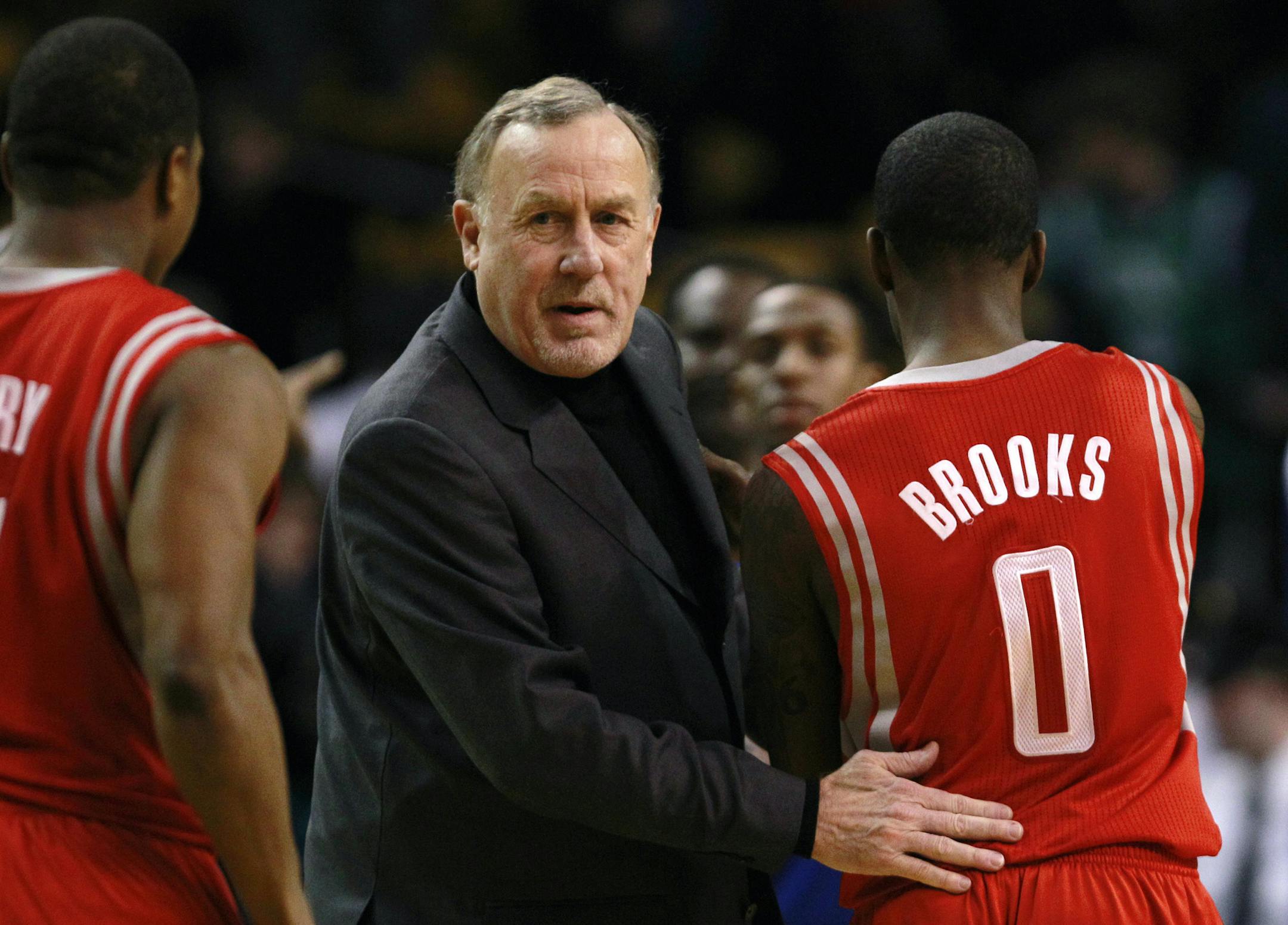 Houston Rockets coach Rick Adelman, left, gives guard Aaron Brooks a pat on the back during the second half of an NBA basketball game in Boston, Monday, Jan. 10, 2011. Brooks scored 24 points as the Rockets beat the Boston Celtics 108-102. (AP Photo/Charles Krupa) ORG XMIT: MIN2013031617115530