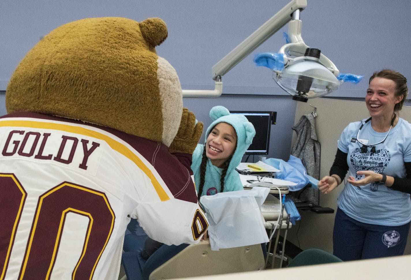 Goldy Gopher gave Leslie Marin a high five after her dental appointment . ] COURTNEY DEUTZ &#x2022; courtney.deutz@startribune.com on Saturday, Feb. 9, 2019 in Moos Tower at the University of Minnesota in Minneapolis. The University of Minnesota's Dental program volunteers hosted Give Kids a Smile - a national program that allows kids to receive free dental care. Goldy was one of a few different characters to visit children throughout the day.