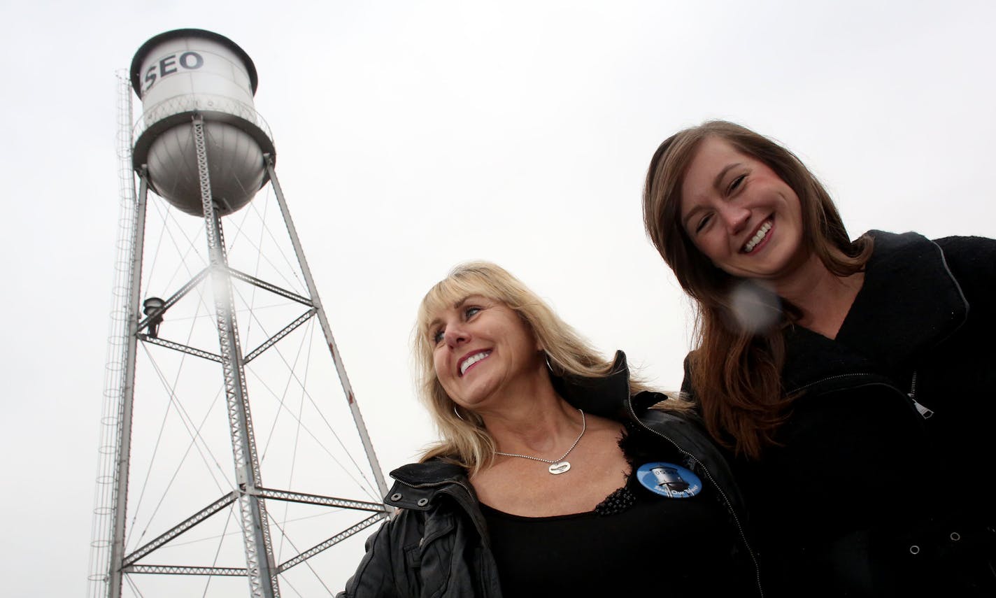 Kathleen Gette, left, and her daughter Lauren Bowe, 24, stood near the old water tower in Osseo. ] (KYNDELL HARKNESS/STAR TRIBUNE) kyndell.harkness@startribune.com In Osseo, Min., Wednesday, November 5, 2014. With the help of her daughter Lauren resident Kathleen Gette is leading the effort to save the iconic structure and add it to the list of 11 Minnesota water towers on the National Historic Registry.