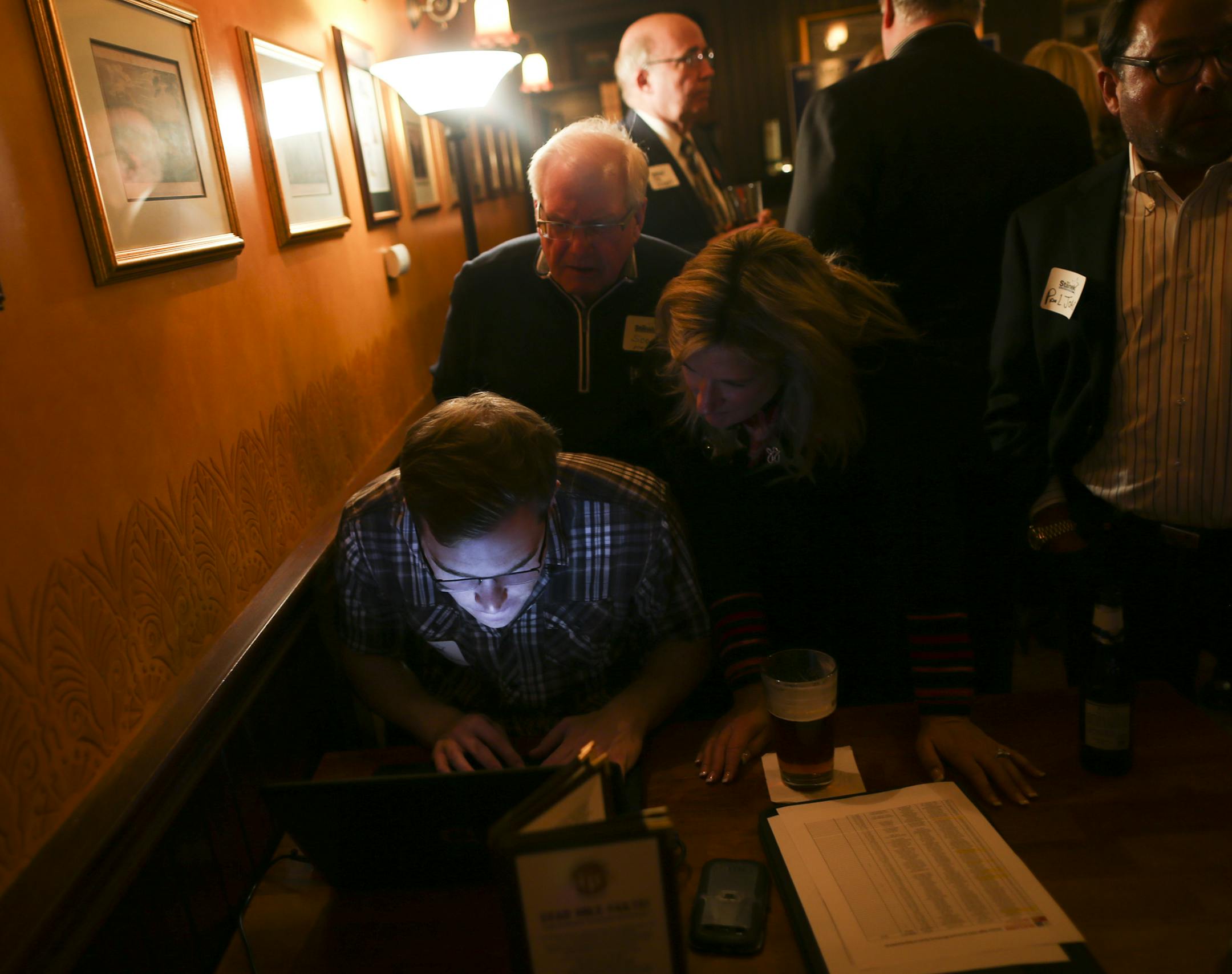 Volunteer Erik Johnson looked at early results of the Hennepin County Sheriff race at incumbent Rich Stanek' election night party at Kip's Irish Pub minutes in St. Louis Park, Minn., on Tuesday, November 4, 2014. ] RENEE JONES SCHNEIDER • reneejones@startribune.com