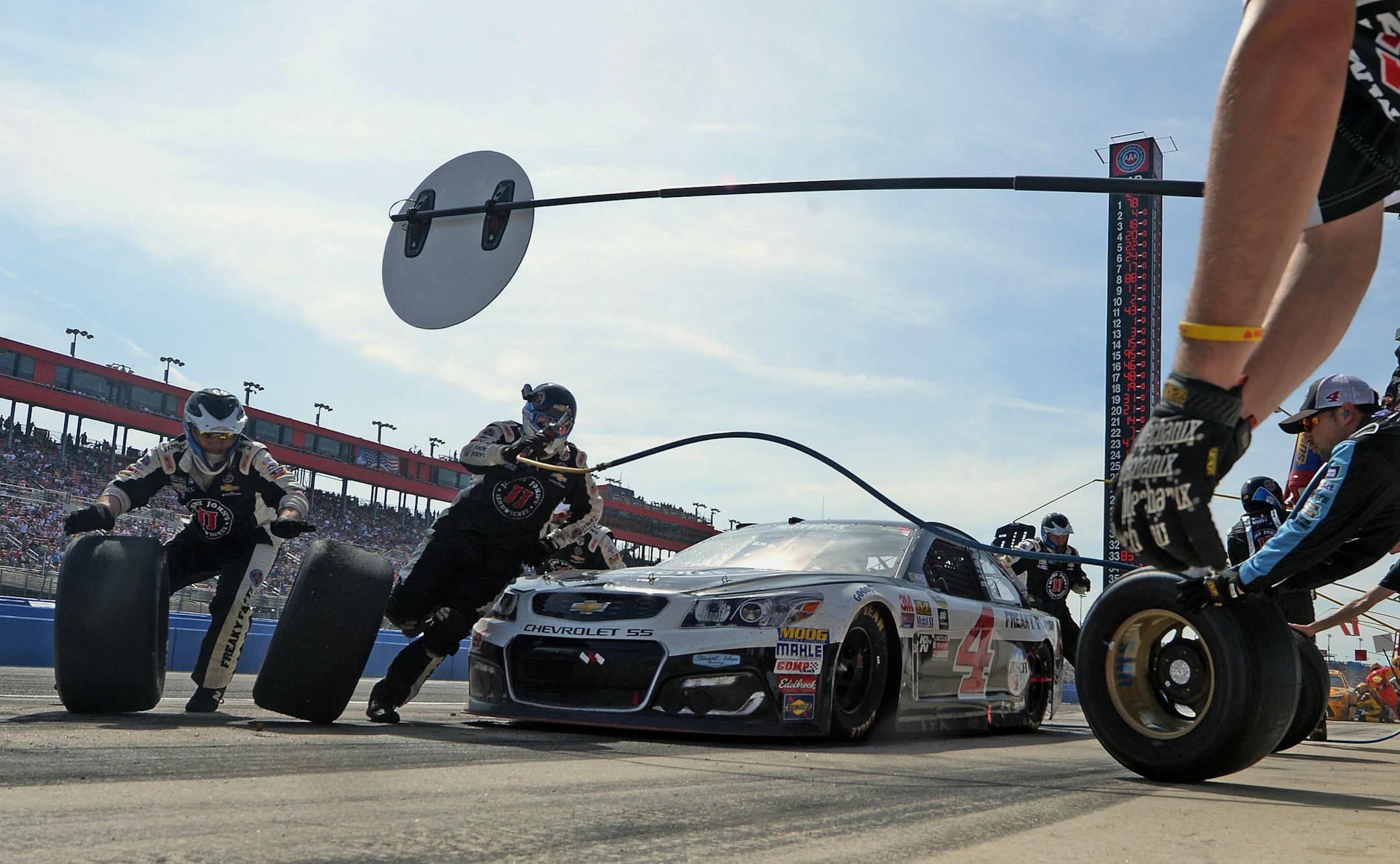 Kevin Harvick made a pit stop during the NASCAR 400 mile auto race Sunday. Jimmie Johnson later pulled away in overtime to beat Harvick for the Southern California native's record sixth NASCAR Sprint Cup Series victory at Fontana, Calif.