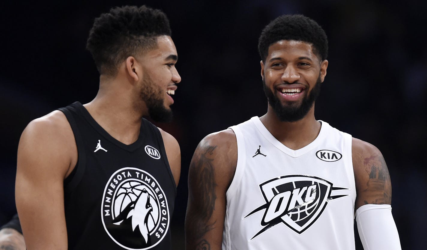 Team Stephen's Karl-Anthony Towns, left, of the Minnesota Timberwolves, and Team LeBron's Paul George, of the Oklahoma City Thunder, talk during the first half of an NBA All-Star basketball game, Sunday, Feb. 18, 2018, in Los Angeles. (AP Photo/Chris Pizzello)