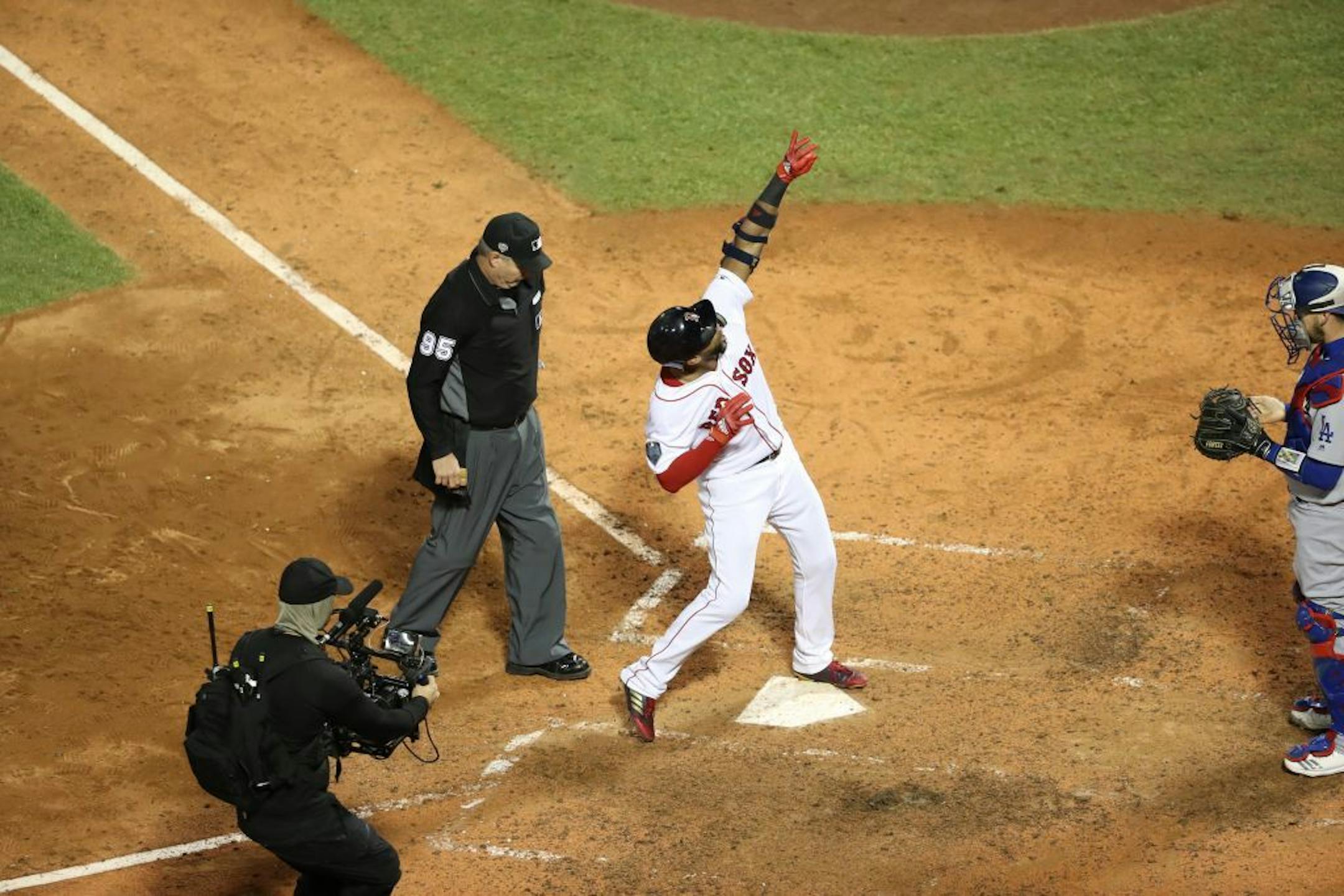 Boston Red Sox player Eduardo Nunez crosses home plate after hitting a three-run homer that broke Game 1 open in the seventh inning of the World Series against the Los Angeles Dodgers, at Fenway Park in Boston, Oct. 23, 2018. It was not the pitchers' duel that many had hoped for, but Chris Sale and a group of Boston relievers managed to get past Clayton Kershaw and the Dodgers bullpen as Boston beat Los Angeles, 8-4.