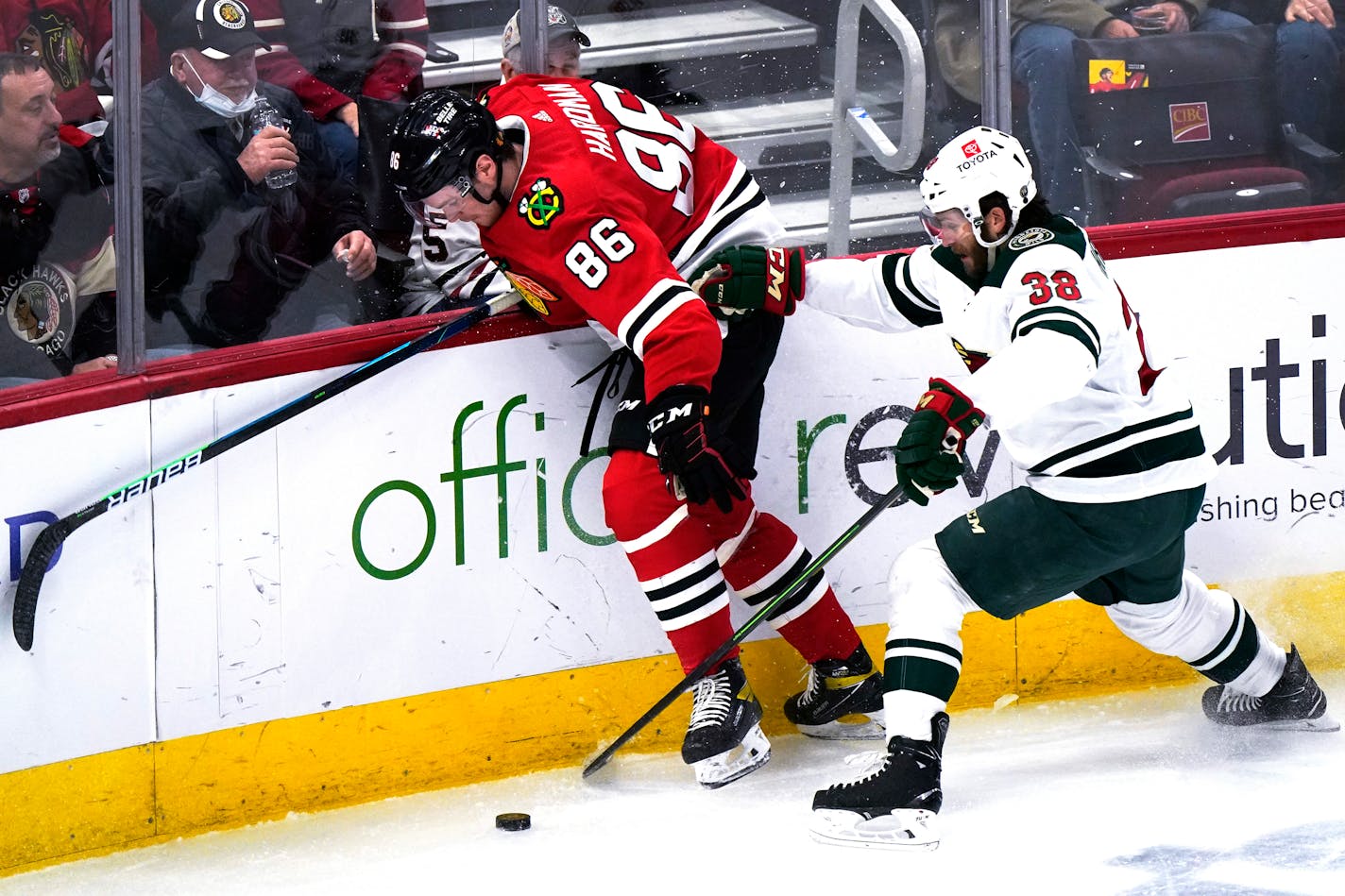 Minnesota Wild right wing Ryan Hartman, right, works for the puck against Chicago Blackhawks left wing Mike Hardman during the third period of an NHL hockey game in Chicago, Friday, Jan. 21, 2022. The Wild won 5-1. (AP Photo/Nam Y. Huh)