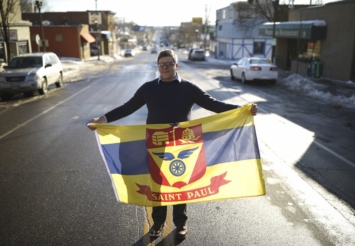 St. Paul geographer Bill Lindeke is leading a movement to fly the City of St. Paul flag. He's shown on Payne Avenue with the flag.