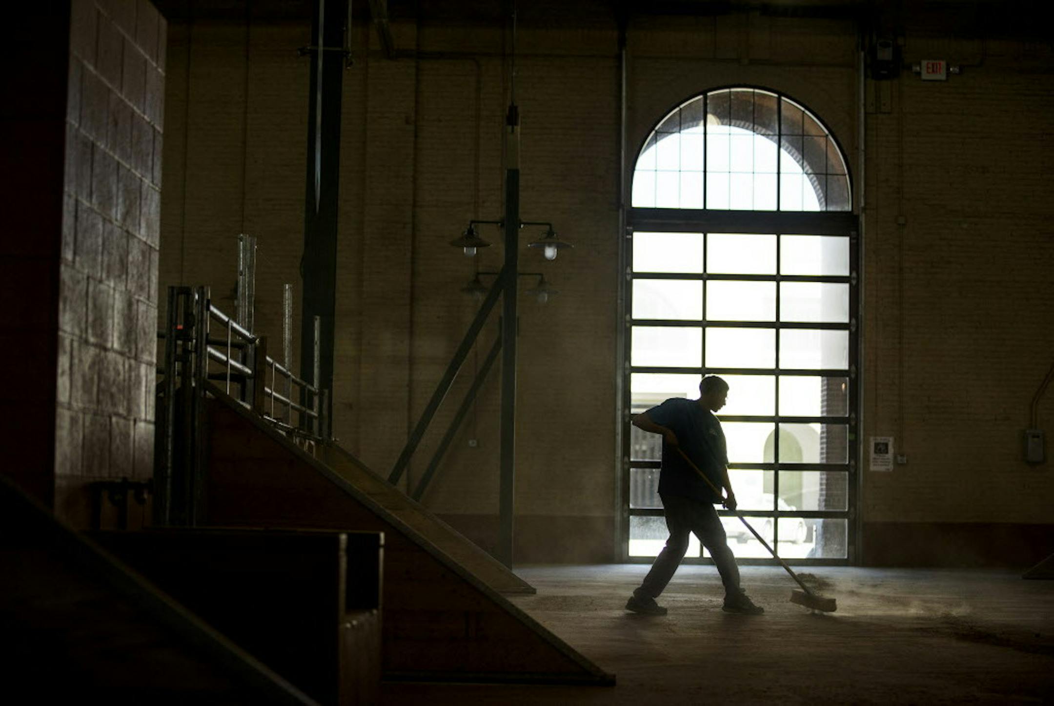 Tyler Craven cleans up the cattle barn at the Minnesota State Fairgrounds in Falcon Heights on Thursday, August 20, 2015. Craven, of St. Croix Falls, Wis., works in the cattle barn and coliseum doing different jobs for the Minnesota State Fair. The cows will arrive next week for the State Fair. ] LEILA NAVIDI leila.navidi@startribune.com /