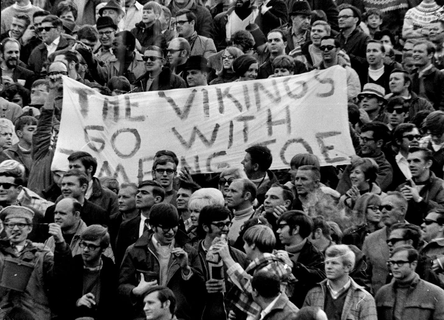 November 10, 1969 Happy Day - Vikings fans held sign (above) which read, "Vikings Go With Jumping Joe," explaining Joe Kapp's quarterback antics (right) which produced three touchdowns on passes. Sigh: "Vikings Go With Jumping Joe" Tells it all Joe Kapp is jumping and Vikings are on the go (below). November 9, 1969 John Croft, Skip Heine, Minneapolis Star Tribune