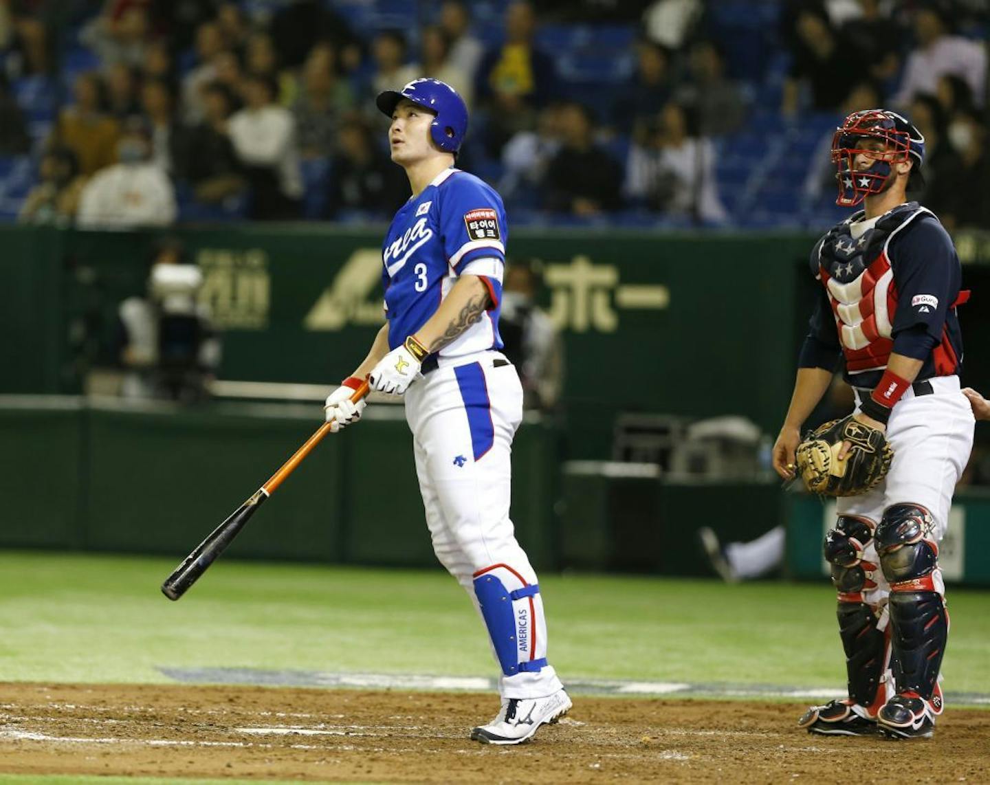 South Korea's Byung Ho Park watches the flight of his three-run home run with USA catcher Dan Rohlfing in the fourth inning of their final game at the Premier12 world baseball tournament at Tokyo Dome in Tokyo, Saturday, Nov. 21, 2015.