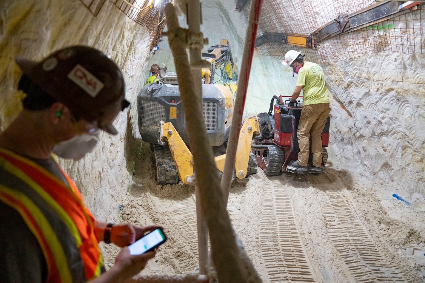 Foreman Eric Fobbe and Jaden Wisti worked to remove sandstone from a new storm water tunnel underneath downtown Minneapolis in July 2022.