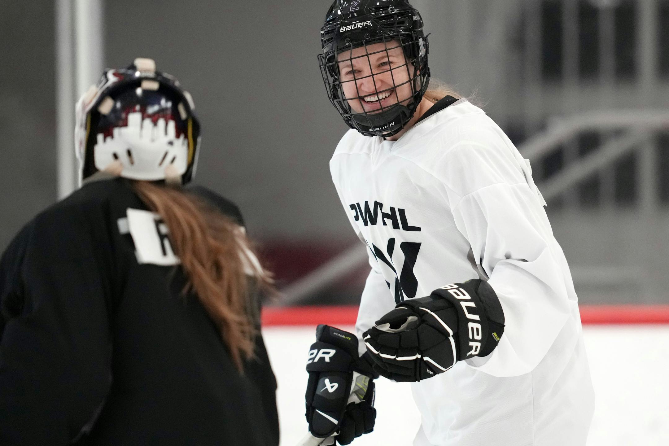 PWHL Minnesota defenseman Lee Stecklein joked with goaltender Maddie Rooney during a recent practice at Tria Rink in St. Paul.