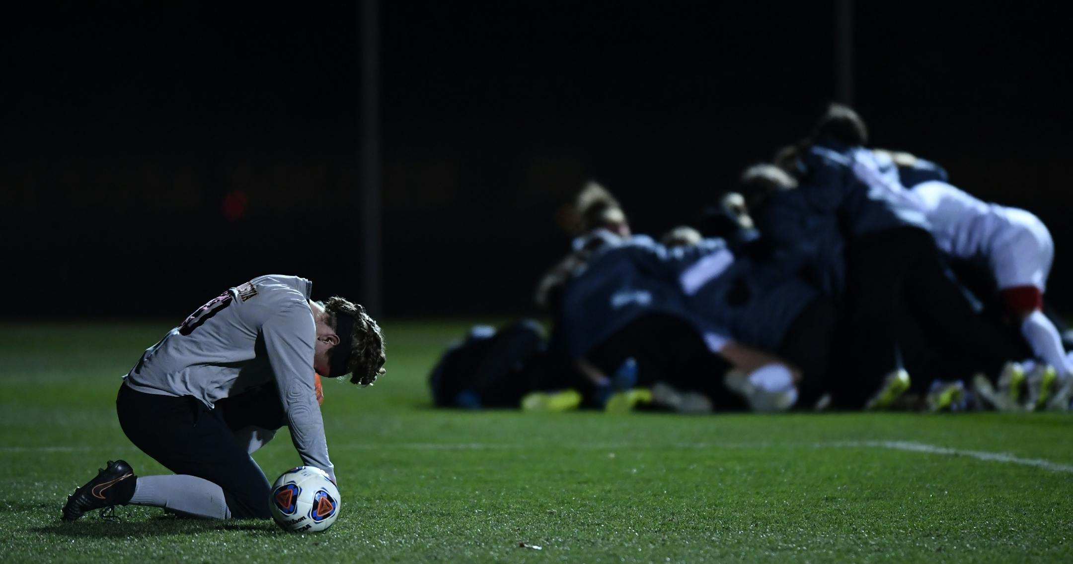 Minnesota goalkeeper Tarah Hobbs (00) was dejected as NC State players celebrated behind her after their 4-2 victory over Minnesota in PKs.