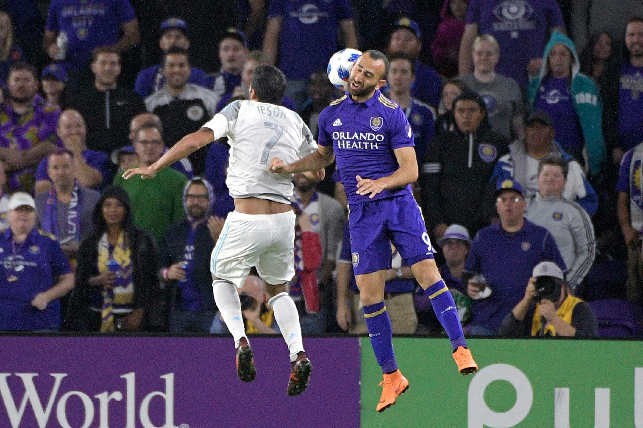Minnesota United midfielder Ibson (7) and Orlando City forward Justin Meram (9) battle for a header during the first half of an MLS soccer match Saturday, March 10, 2018, in Orlando, Fla. Minnesota won 2-1. (Phelan M. Ebenhack for the Star-Tribune) ORG XMIT: OTKMINN122