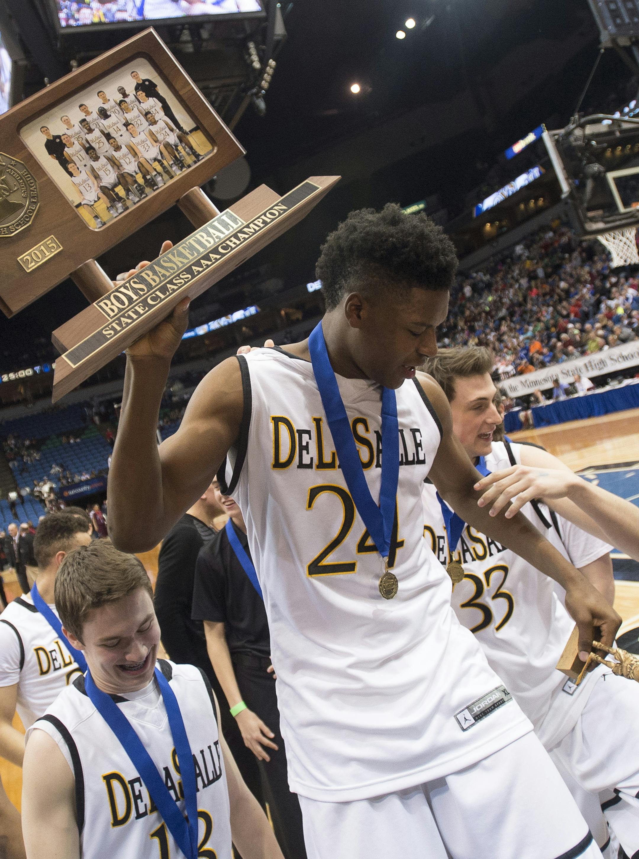 DeLaSalle forward Joshua Collins (24) hoists his team's 3A championship trophy over his head after defeating St. Paul Johnson 82-64. ] (Aaron Lavinsky | StarTribune) St. Paul Johnson takes on DeLaSalle in the Class 3A boys' basketball championship game on Saturday, March 14, 2014 at Target Center.