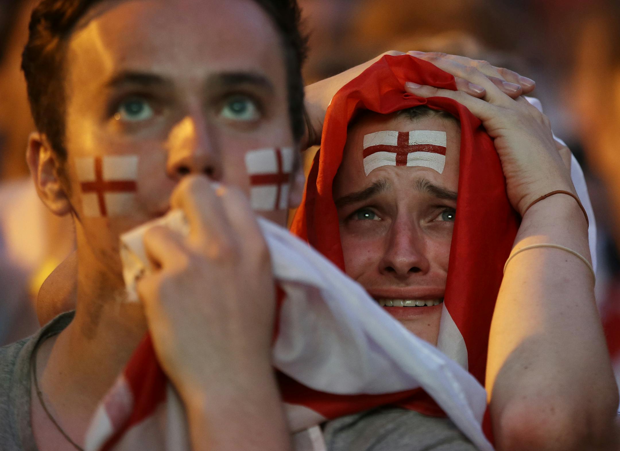 England soccer fans react after Croatia scored their side's second goal as they watch a live broadcast on a big screen of the semifinal match between Croatia and England at the 2018 soccer World Cup, in Flat Iron Square, south London, Wednesday, July 11, 2018. (AP Photo/Luca Bruno)