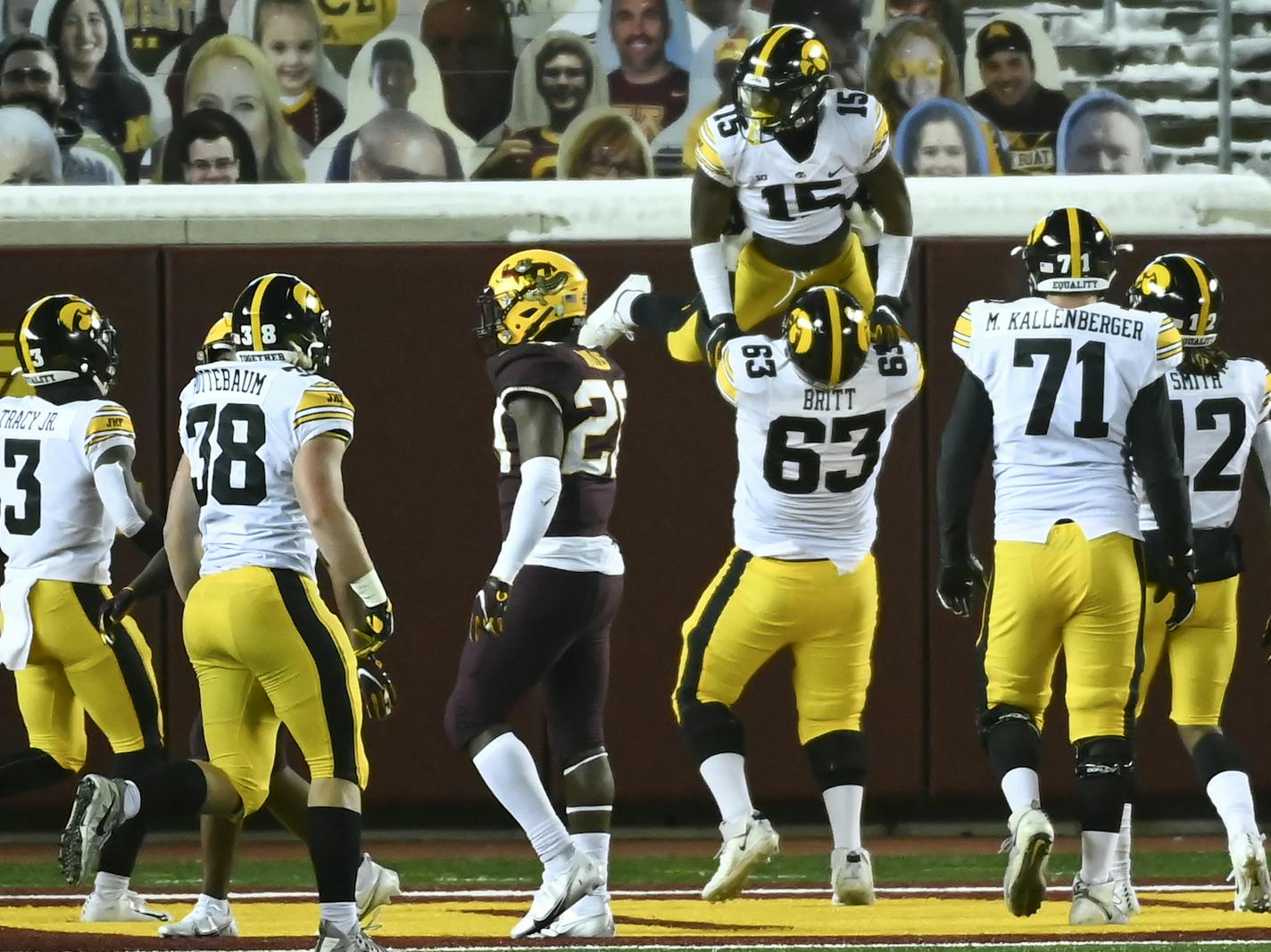 Iowa offensive lineman Justin Britt (63) lifted running back Tyler Goodson (15) into the air after Goodson's second quarter rushing touchdown