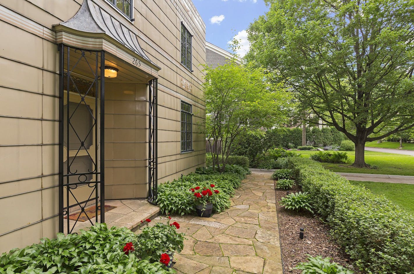 Ornamental ironwork marks the entry portico.