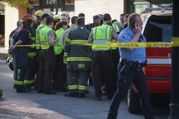 Minneapolis firefighters gathered in Dinkytown on Tuesday before police took over the investigation of the substance in a residential building.