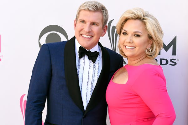 FILE - Todd Chrisley, left, and his wife, Julie Chrisley, pose for photos at the 52nd annual Academy of Country Music Awards on April 2, 2017, in Las 