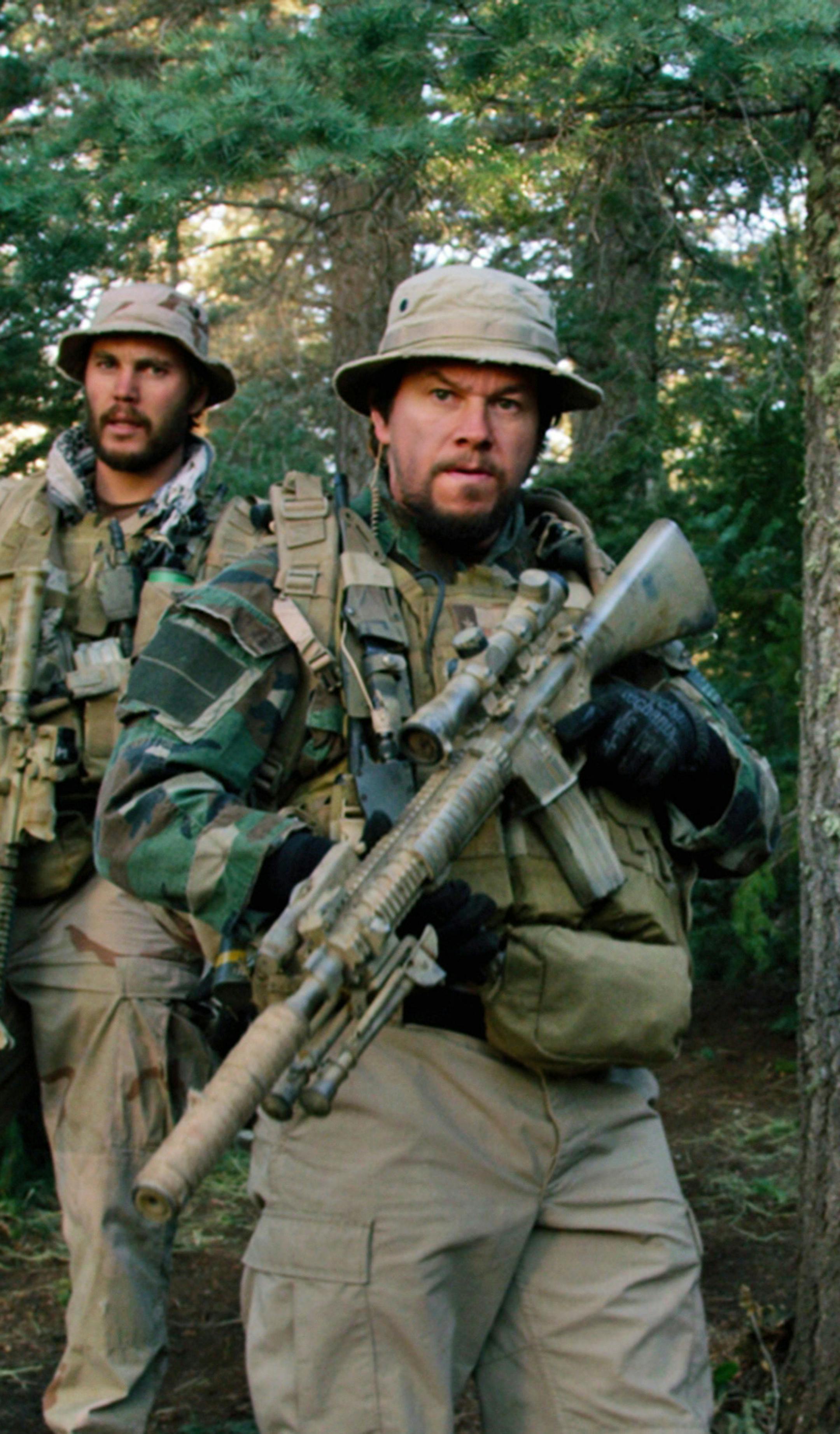 This photo released by Universal Pictures shows, from left, Taylor Kitsch, as Michael Murphy, Mark Wahlberg as Marcus Luttrell, Ben Foster as Matt ìAxeî Axelson, and Emile Hirsch as Danny Dietz in a scene from the film, ìLone Survivor." The Navy SEAL drama earned $37.8 million in its first weekend of wide release. (AP Photo/Universal Pictures)