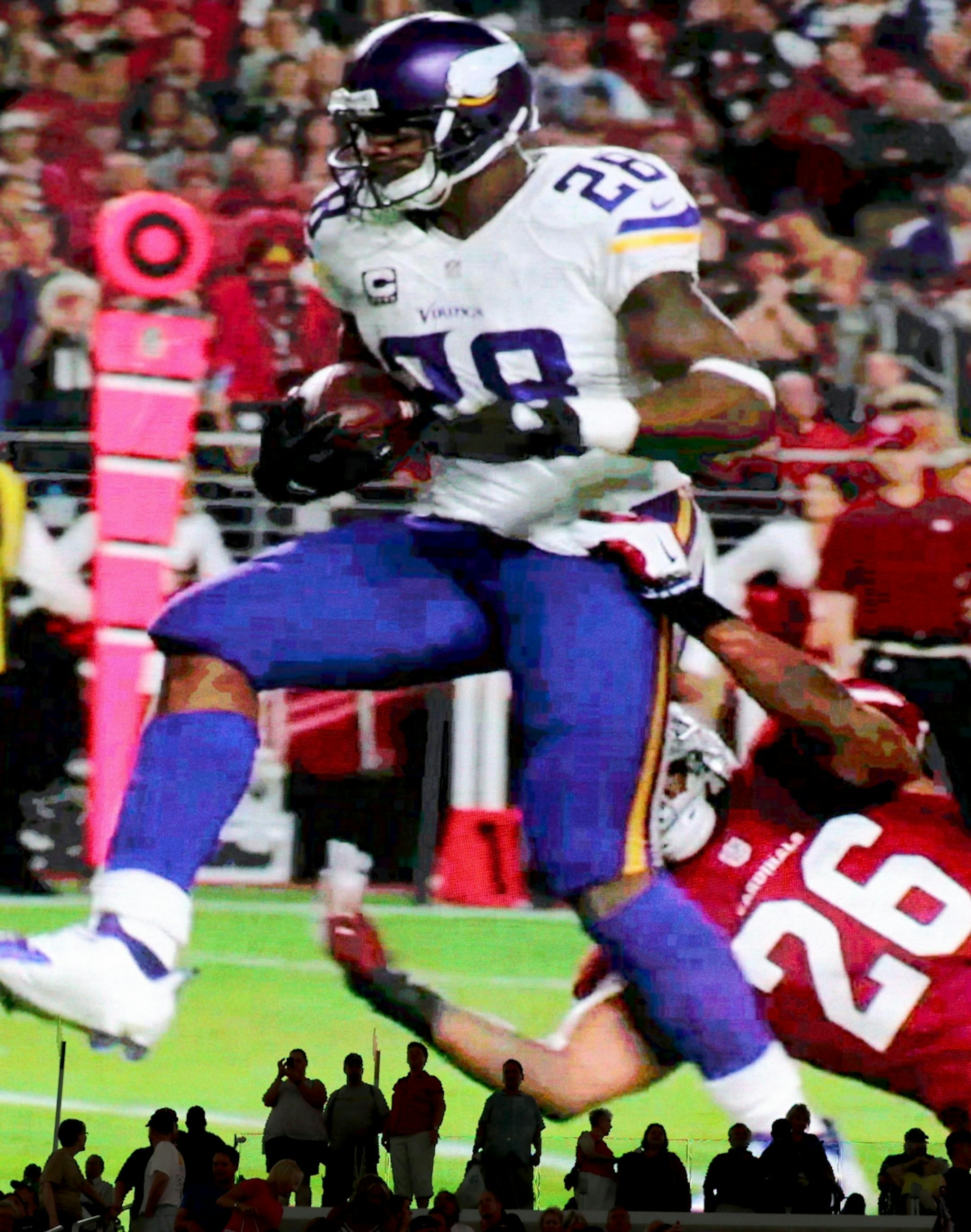 On a giant video monitor, Minnesota Vikings running back Adrian Peterson is seen on a highlight reel at the new U.S. Bank Stadium during an open house for the public Saturday, July 23, 2016, in Minneapolis, MN.