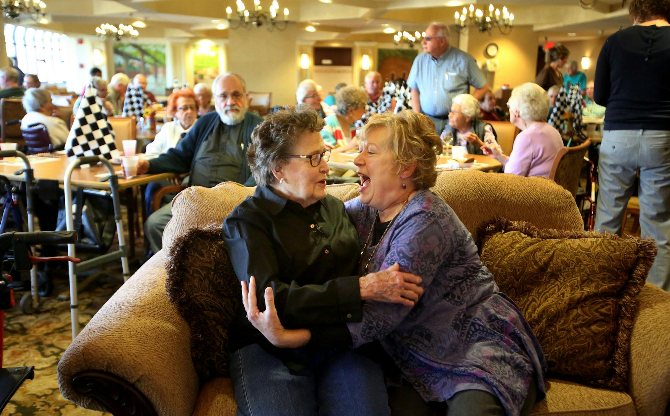 Pam Quinn, front right, a close friend of Louise Spencer, 92, greeted Spencer before her party.