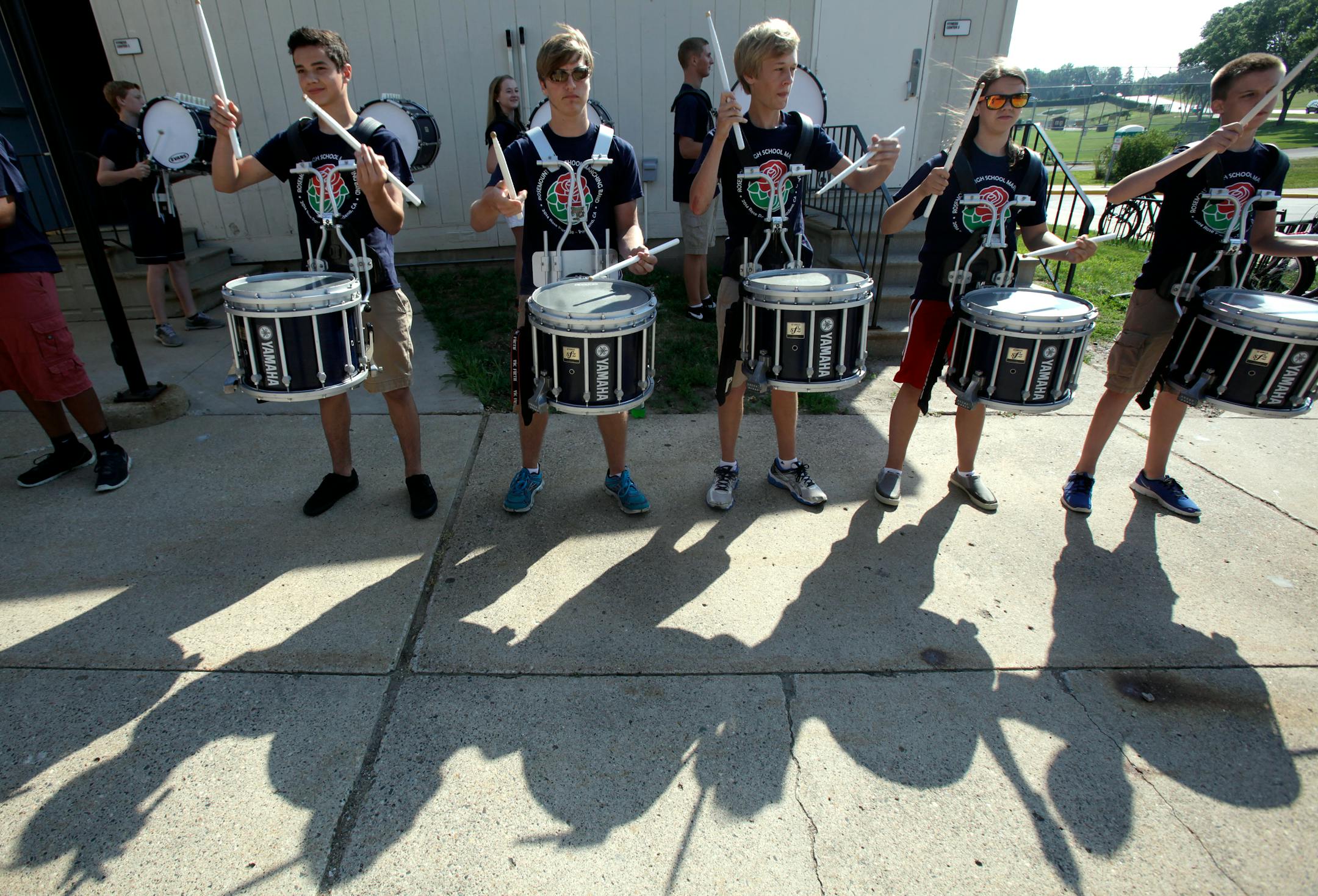 The Marching band practices for the arrival of the President of the Tournament of Roses' Scott Jenkins and his wife Cindy Jenkins at Rosemount High School on July 12, 2013.