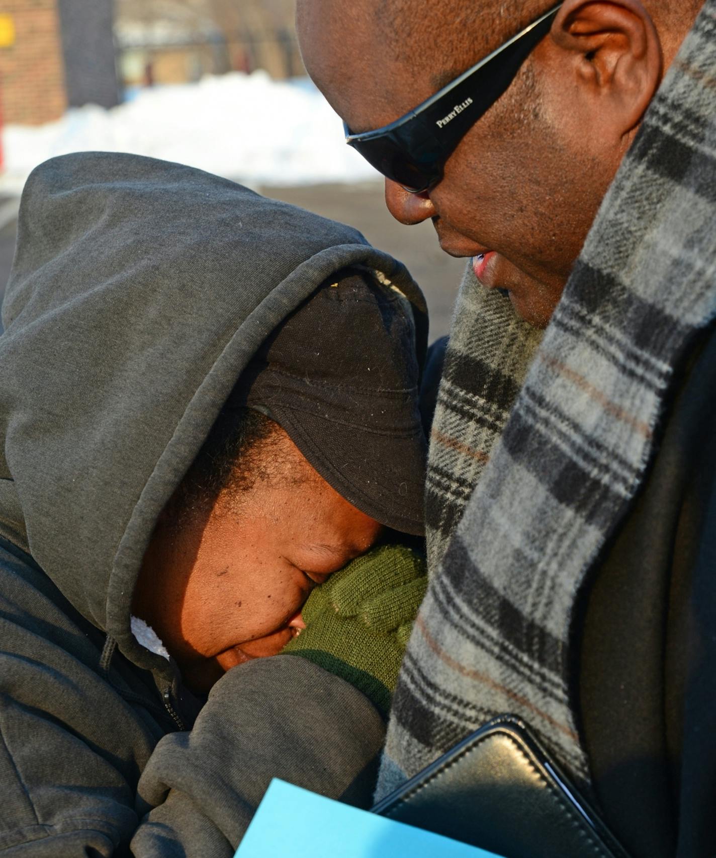 Shooting scene where two people were fatally shot and another was wounded early Friday at an after-hours establishment at 39th St. and Fremont Av. N. in Minneapolis. Monique White of Minneapolis was comforted by pastor Harding Smith after learning that her step son was one of the people killed.