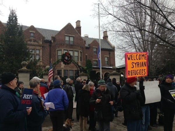 About 100 people rallied Sunday, Dec. 6, at the governor's residence in St. Paul to support leaving the state open to Syrian refugees seeking asylum i