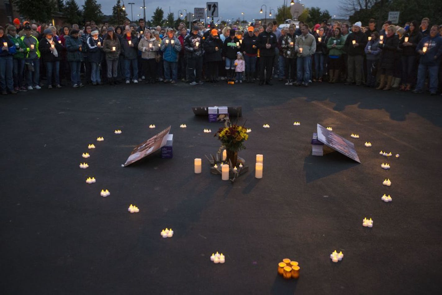 People stood in a heart shape around a heart of candles and pictures of Joseph Brunn during a candlelight vigil for him after his body was discovered earlier in day in the Mississippi River on Thursday October 8, 2015, outside the Holiday Inn in Otsego, Minn.,.