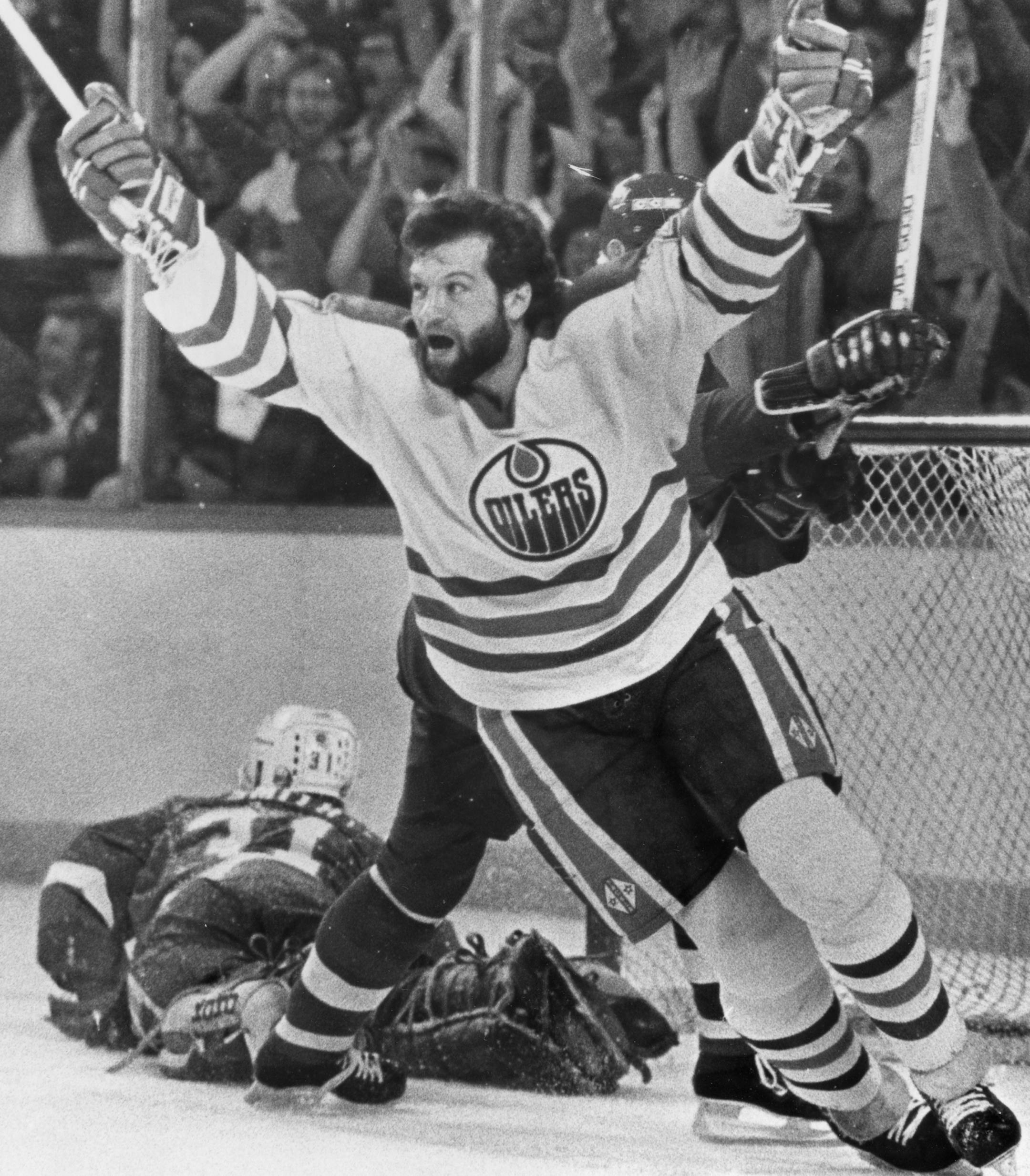 In this May 19, 1984, file photo, Edmonton Oilers' Dave Semenko celebrates a goal by teammate Wayne Gretzky (not shown) past New York Islanders' goaltender Billy Smith during an NHL game in Edmonton Former Edmonton Oilers tough guy Dave Semenko, who protected Wayne Gretzky in the 1980s, has died. He was 59. The Oilers say Semenko died after a short battle with cancer. A team spokesman said Semenko died in Edmonton. (Larry MacDougal/The Canadian Press via AP, File)