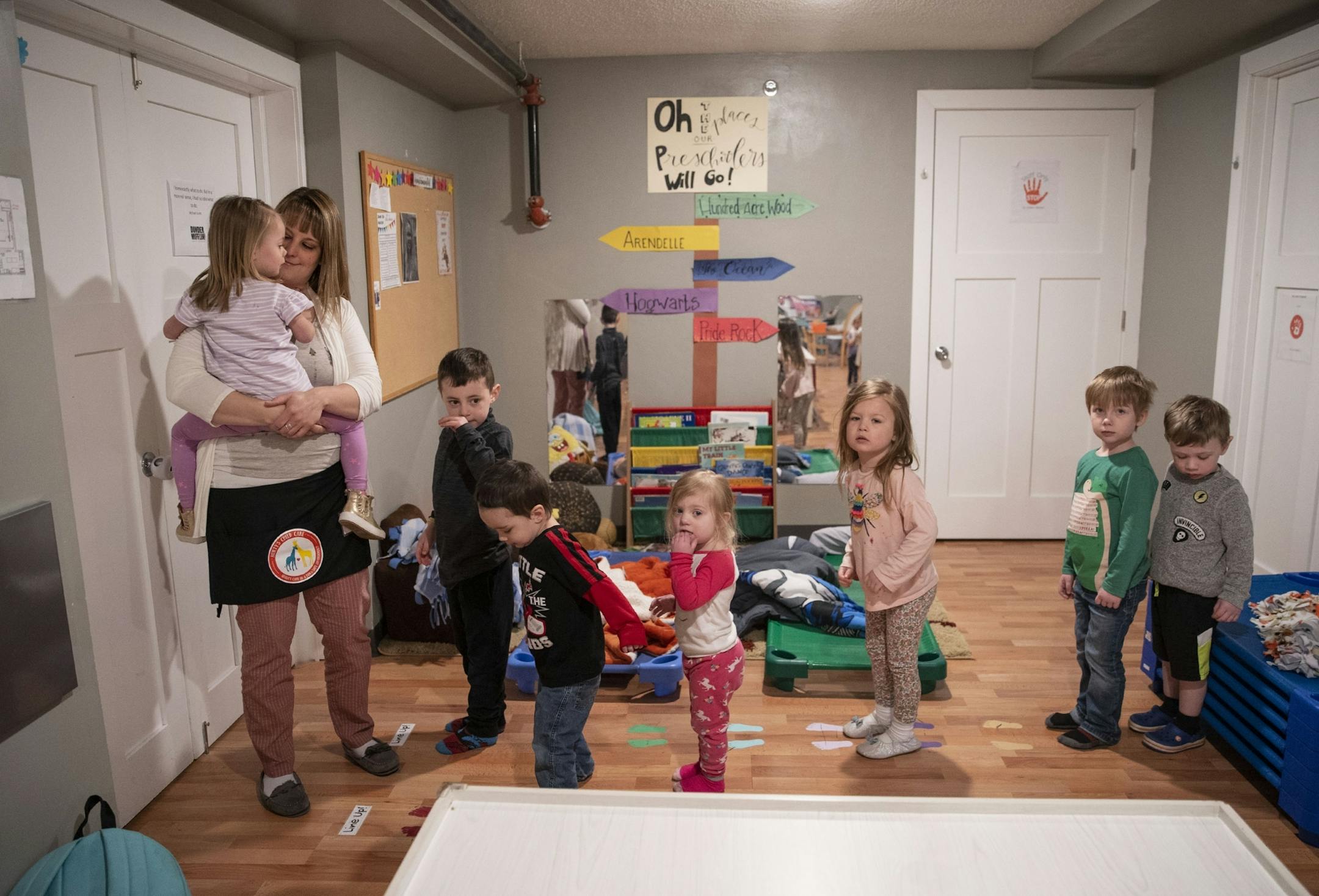 (Left) April Westman got pre-school aged kids lined up to go play outside at Aunty's Child Care in Duluth, MN on Thursday.