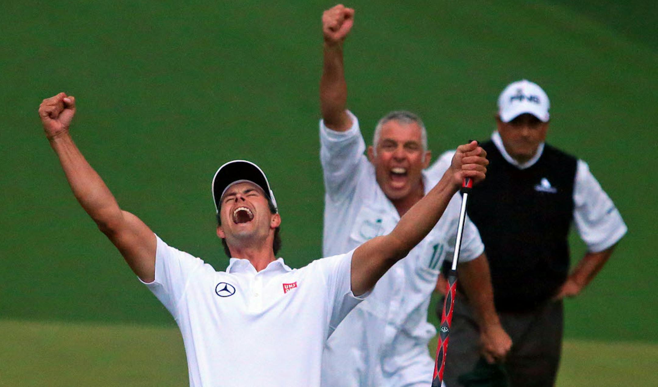 Adam Scott and his caddie, Steve Williams, reacted to Scott's birdie putt dropping on the second playoff hole, after Angel Cabrera, back, had missed his chance.