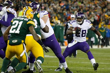 Minnesota Vikings' Adrian Peterson runs during the second half an NFL football game against the Green Bay Packers Sunday, Jan. 3, 2016, in Green Bay, 