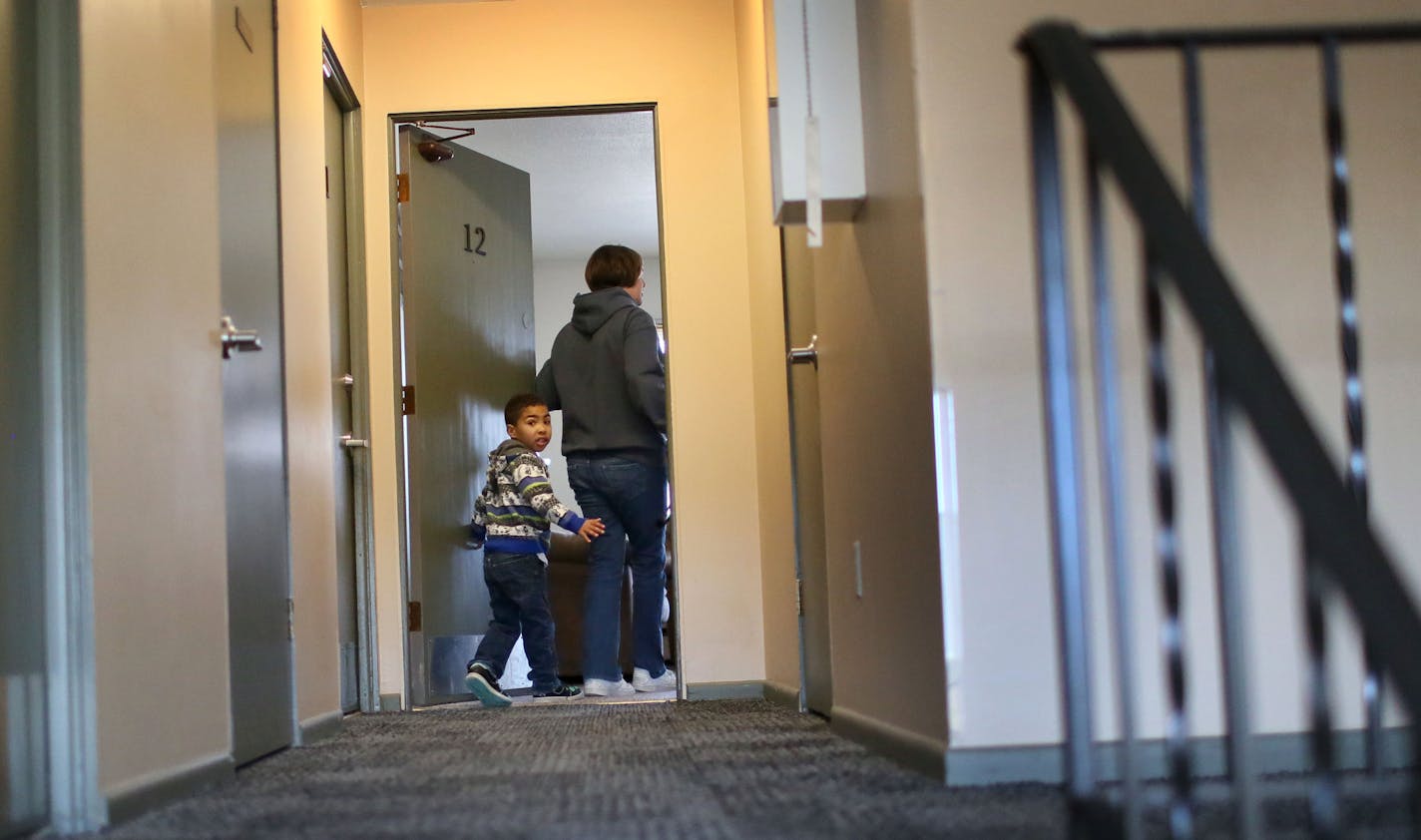 Michaella Waters prepared her five-year-old son, Jordan, who is autistic, for school Thursday, April 23, 2015, outside their apartment building in St. Louis Park, MN. Finally eligible for section 8 housing, the single mother has made more than 50 calls a week to landlords, in her quest to find a rental unit in the suburbs that accepts Section 8, a federal housing voucher. Waters has been on a wait list for the voucher for more than seven years. Waters says she has done all the right things to be