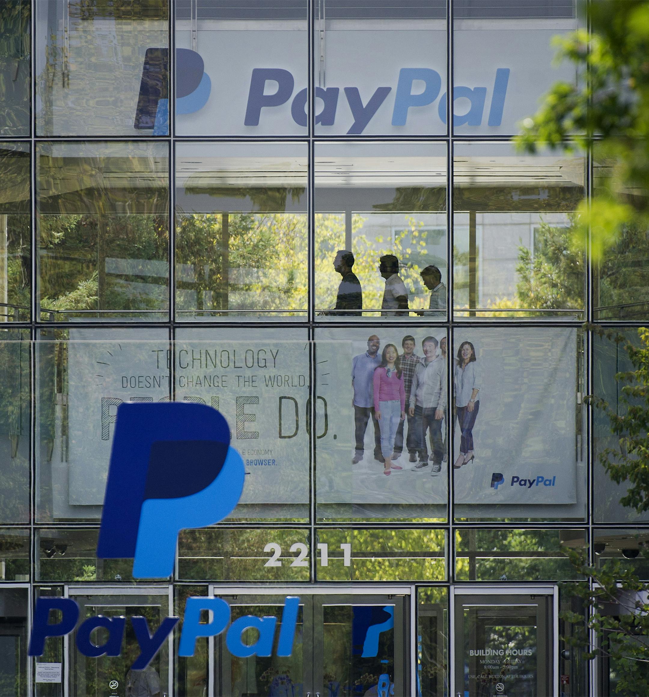 PayPal signage is displayed in front of eBay Inc. headquarters in San Jose, California, U.S., on Tuesday, Sept. 30, 2014. EBay Inc. is spinning off its PayPal division, heeding demands by activist shareholder Carl Icahn and giving the business independence it can use to contend with rising competition from Apple Inc. and Google Inc. Photographer: David Paul Morris/Bloomberg ORG XMIT: 516003783