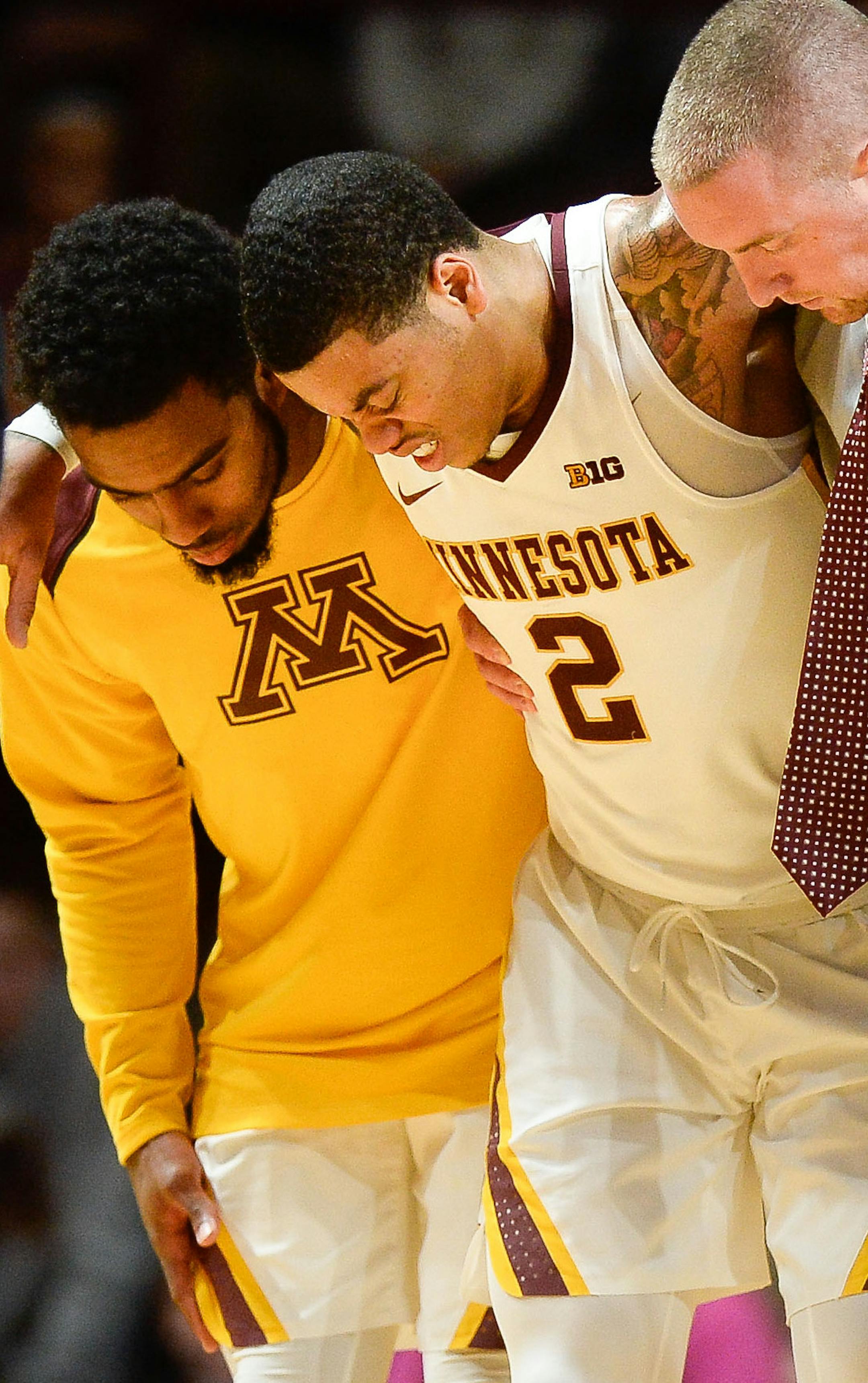 Minnesota Golden Gophers guard Nate Mason (2) winced in pain as he was helped off the floor after suffering a leg injury in the second half against the Florida Atlantic Owls. ] AARON LAVINSKY ï aaron.lavinsky@startribune.com The University of Minnesota Golden Gophers men's basketball team played the Florida Atlantic University Owls on Saturday, Dec. 23, 2017 at Williams Arena in Minneapolis, Minn.