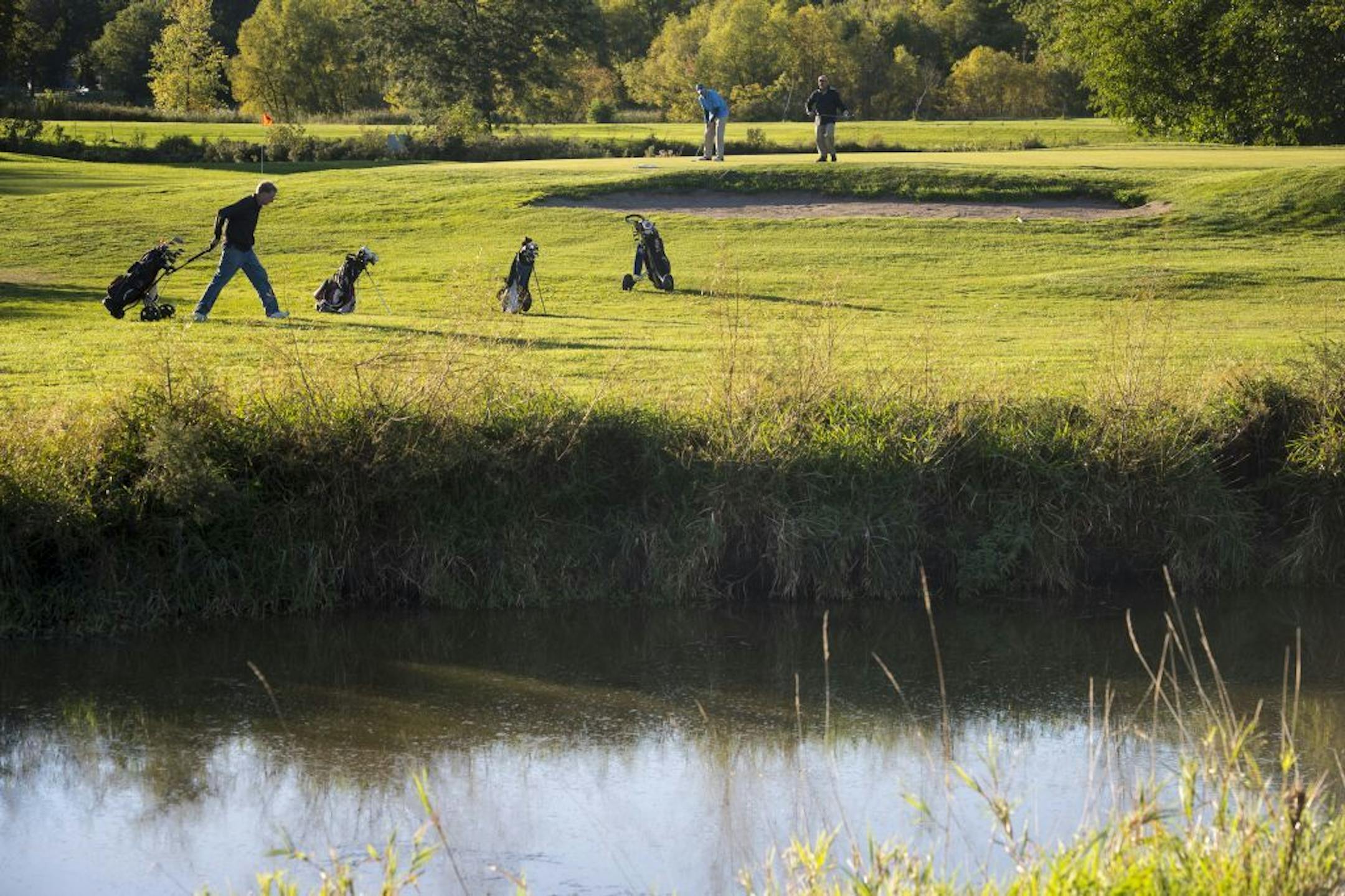 Golfers played near Pond E at Hiawatha Golf Course Wednesday afternoon.